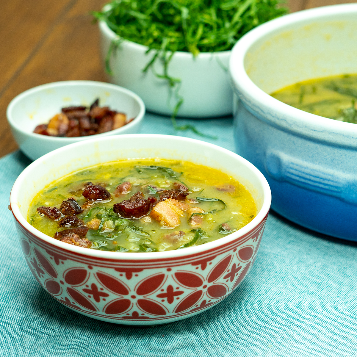 Caldo Verde Portuguese kale and potato soup served in a bowl with smoked sausages.