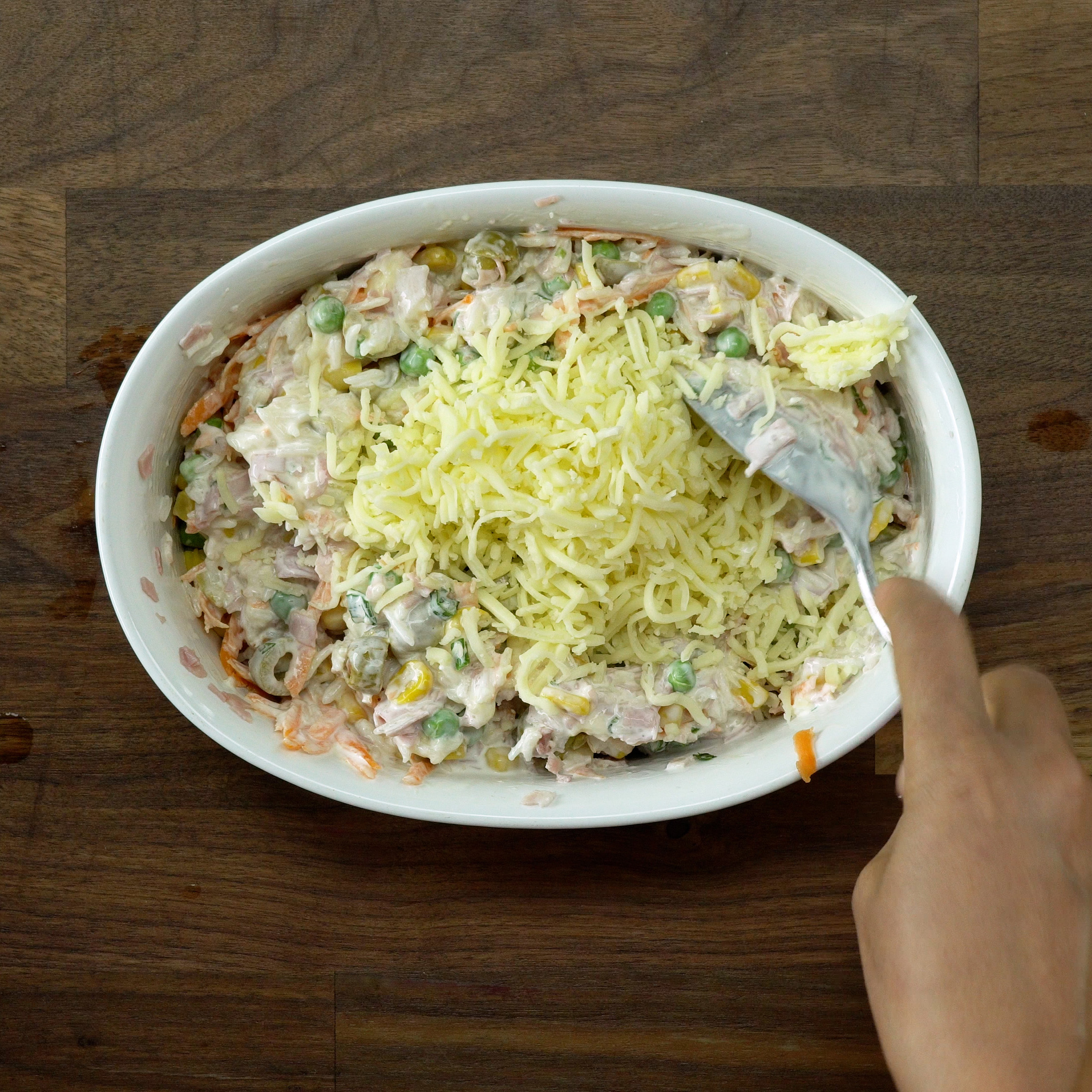 Adding mozzarella to the baked creamy rice.