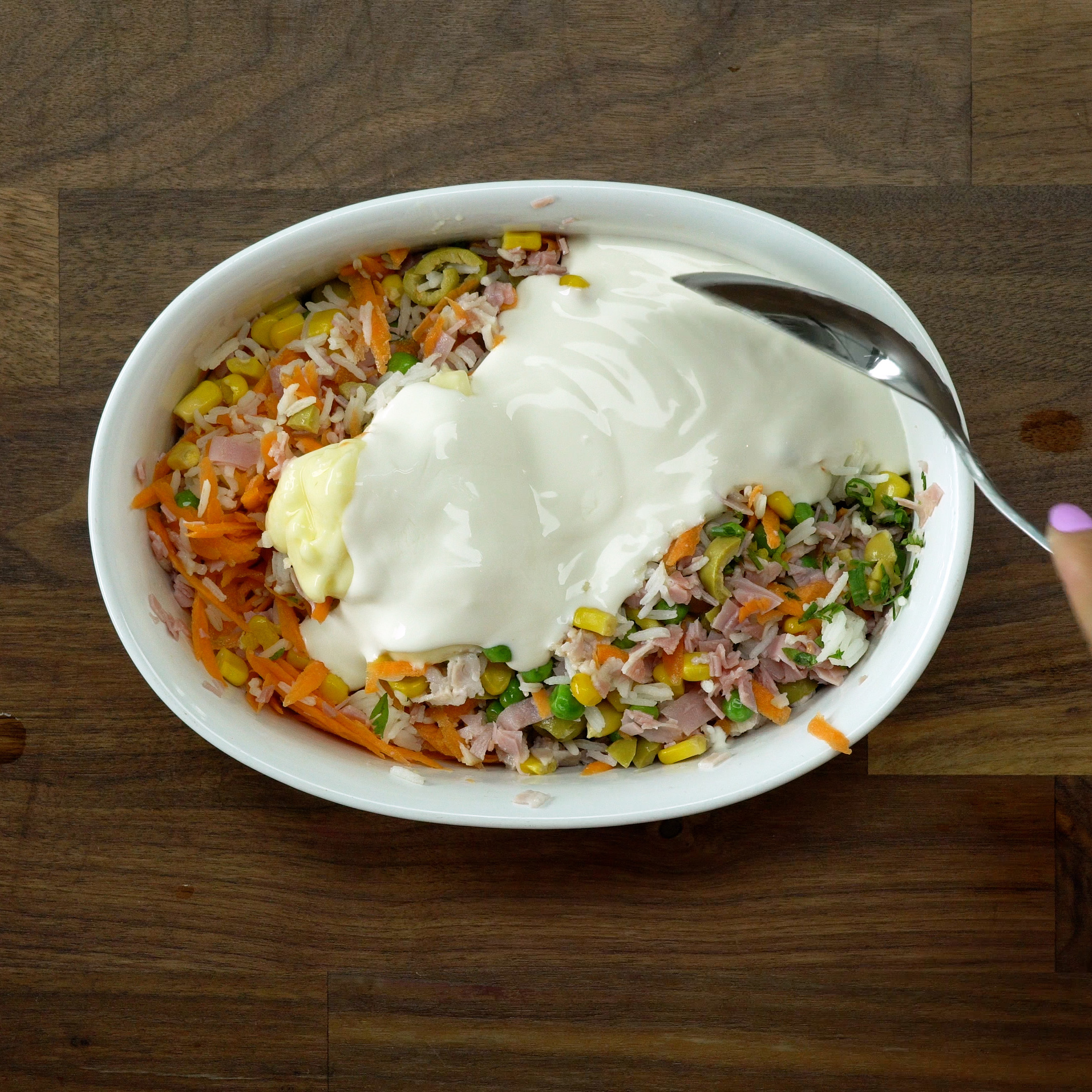 Adding cream cheese and heavy cream and mixing into the rice.