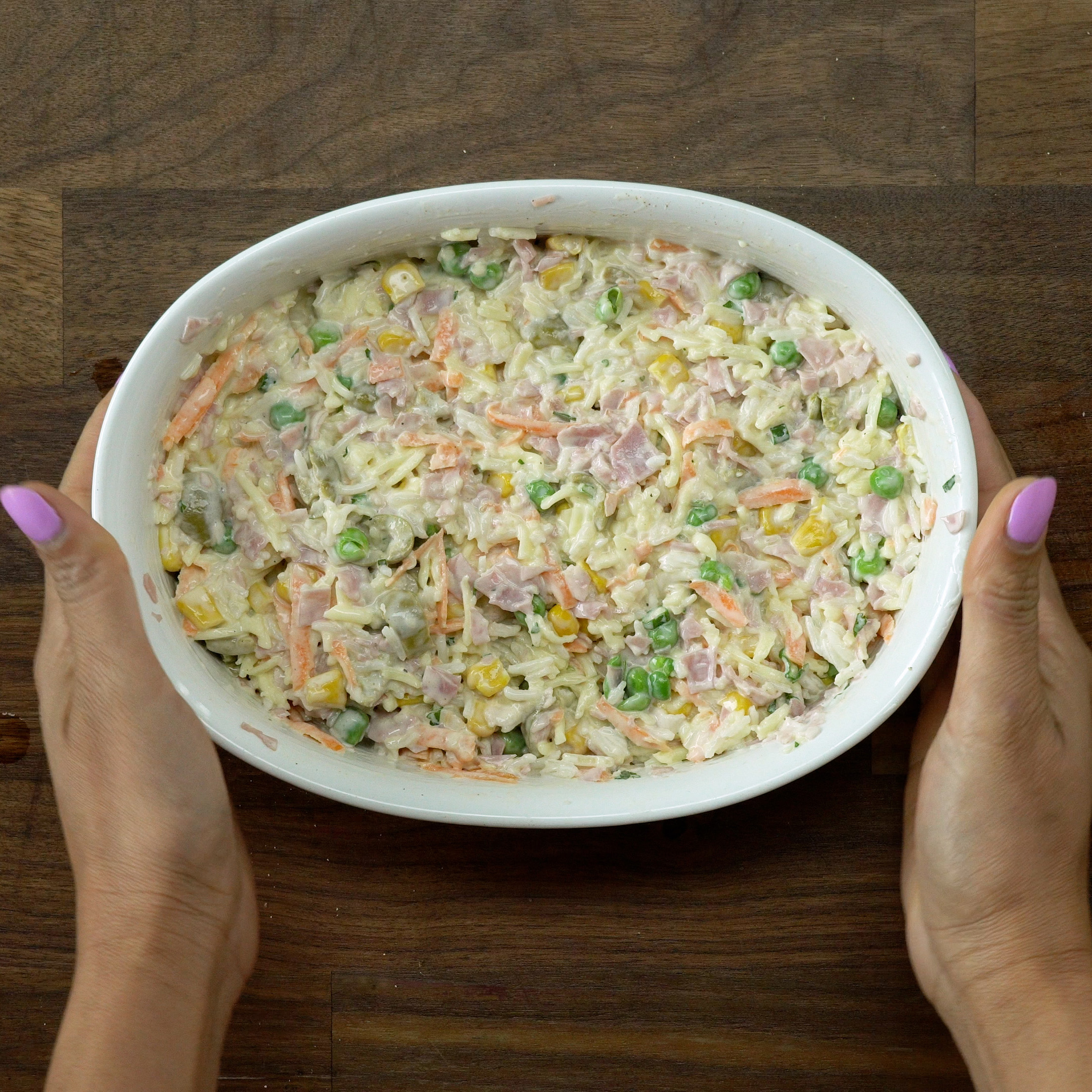 Baking dish of baked creamy rice going into the oven.