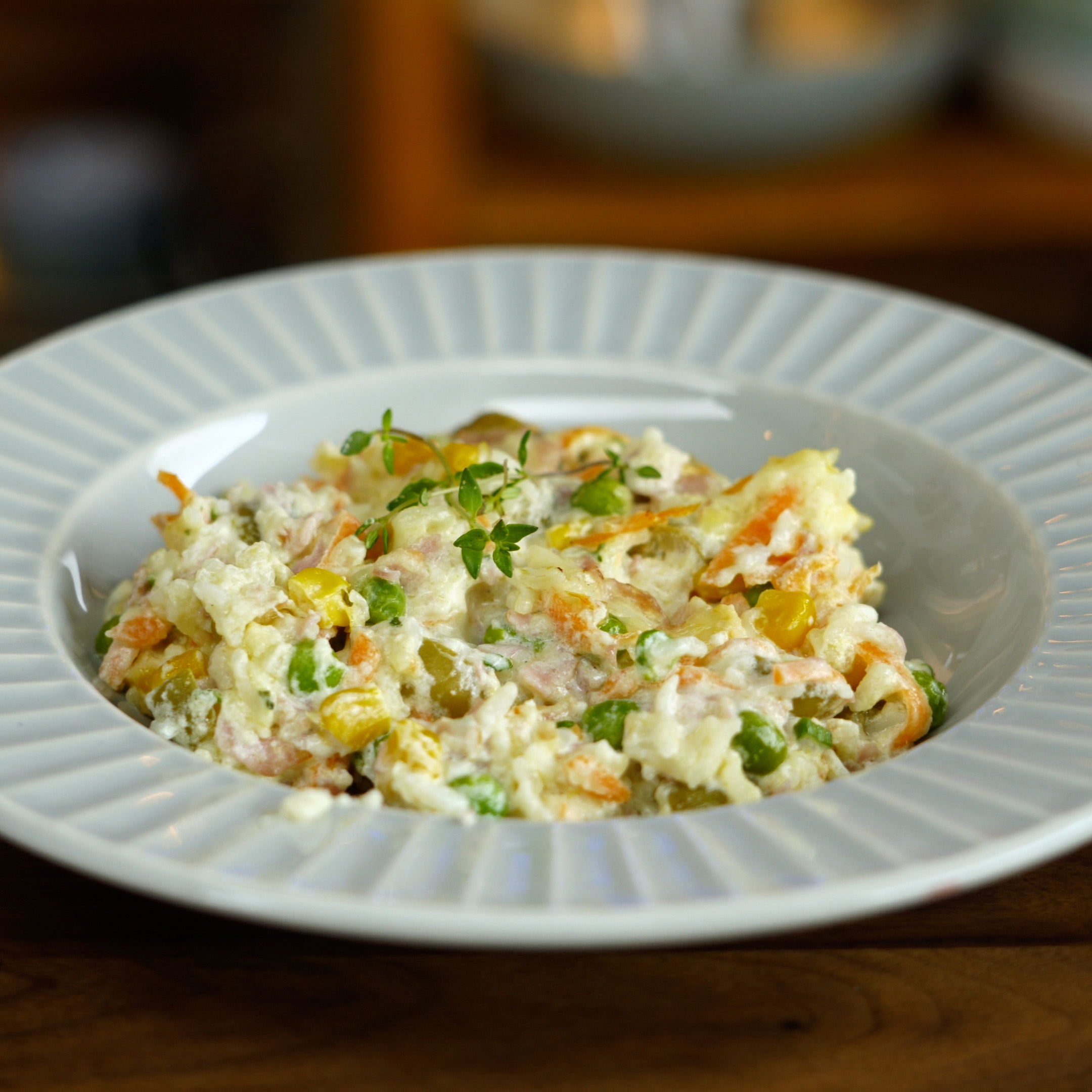 Baked creamy rice with bacon and ham ready to serve.