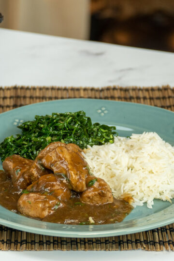 Beer braised pork tenderloin bites served with rice and greens.