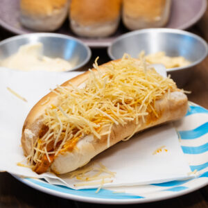 Brazilian hot dogs with creamy sausage sauce, corn and crispy potato sticks.
