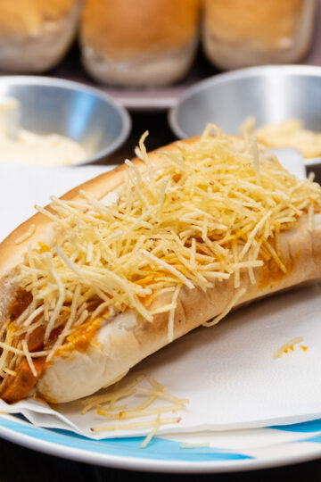 Brazilian hot dogs with creamy sausage sauce, corn and crispy potato sticks.