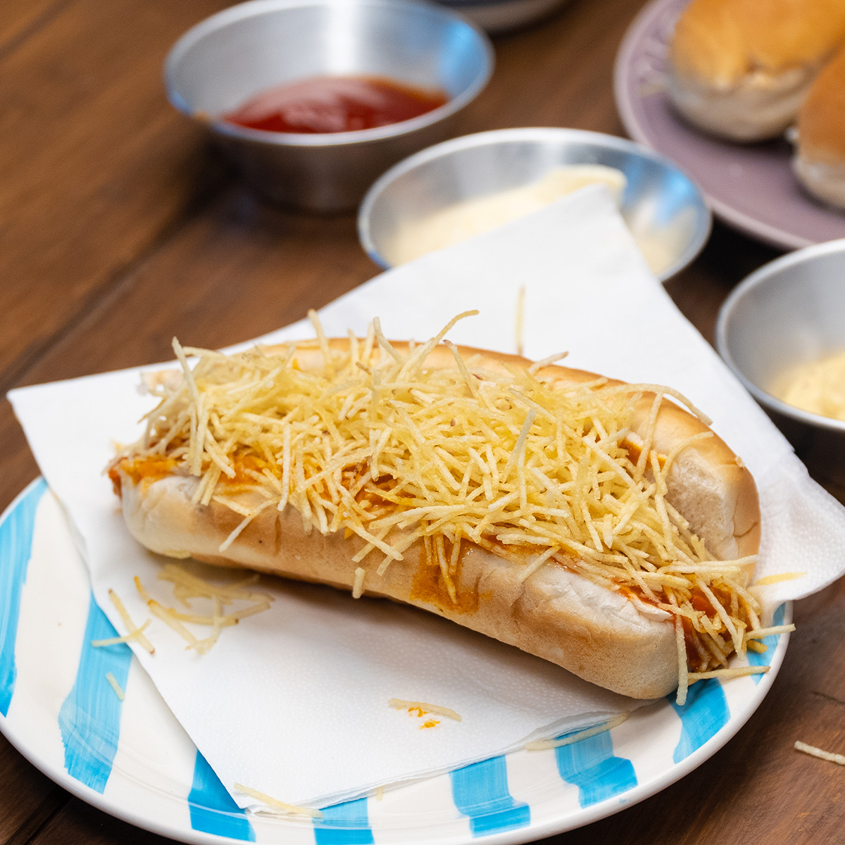 Creamy Brazilian hot dogs topped with corn and potato sticks.