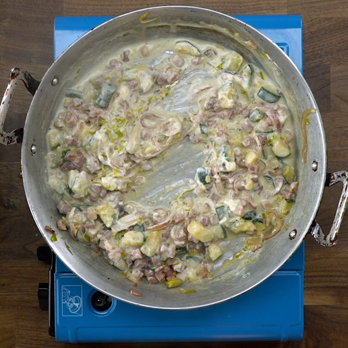Creamy sauce being prepared in a skillet.
