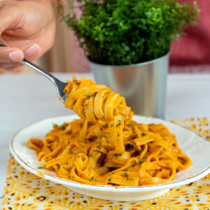 Plated tagliatelle with creamy shrimp sauce.