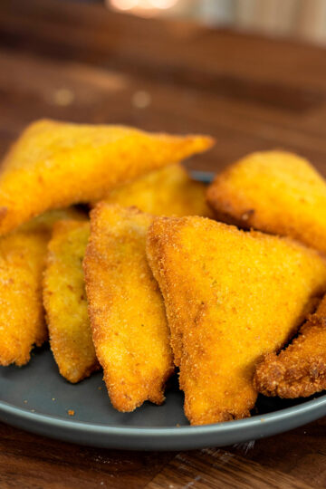 Plated crispy fried sandwich bread pockets.