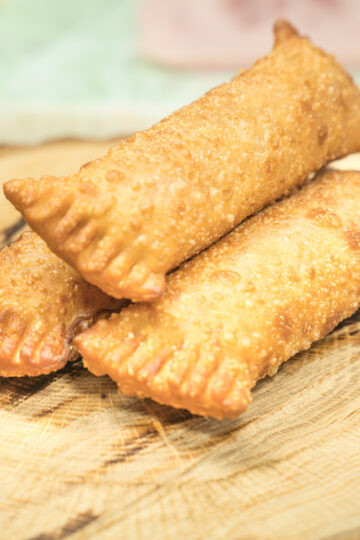 Crispy ham and cheese rolls being served.