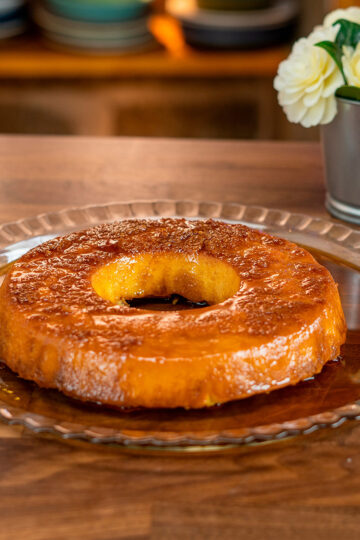 Sliced condensed milk bread pudding served on a plate with caramel sauce.