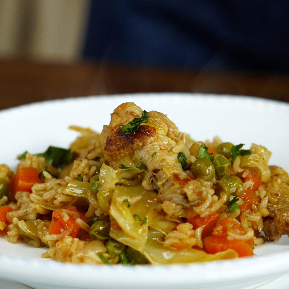 Chicken wings and rice finished with fresh parsley and served hot.