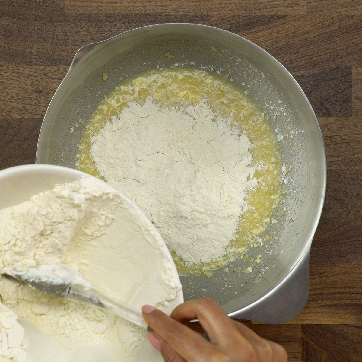 Flour being added to potato roll dough.