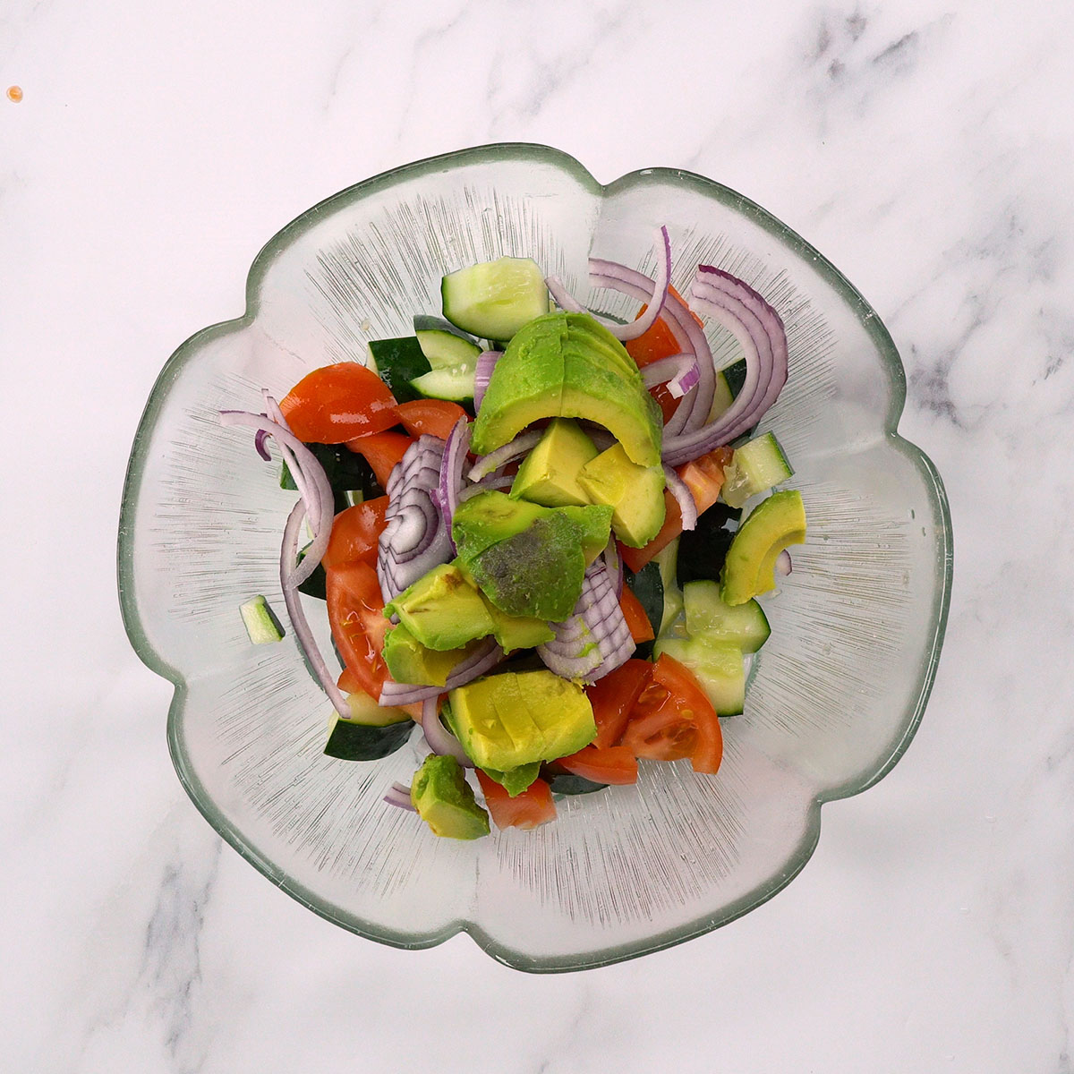 Salad ingredients mixed in a bowl.
