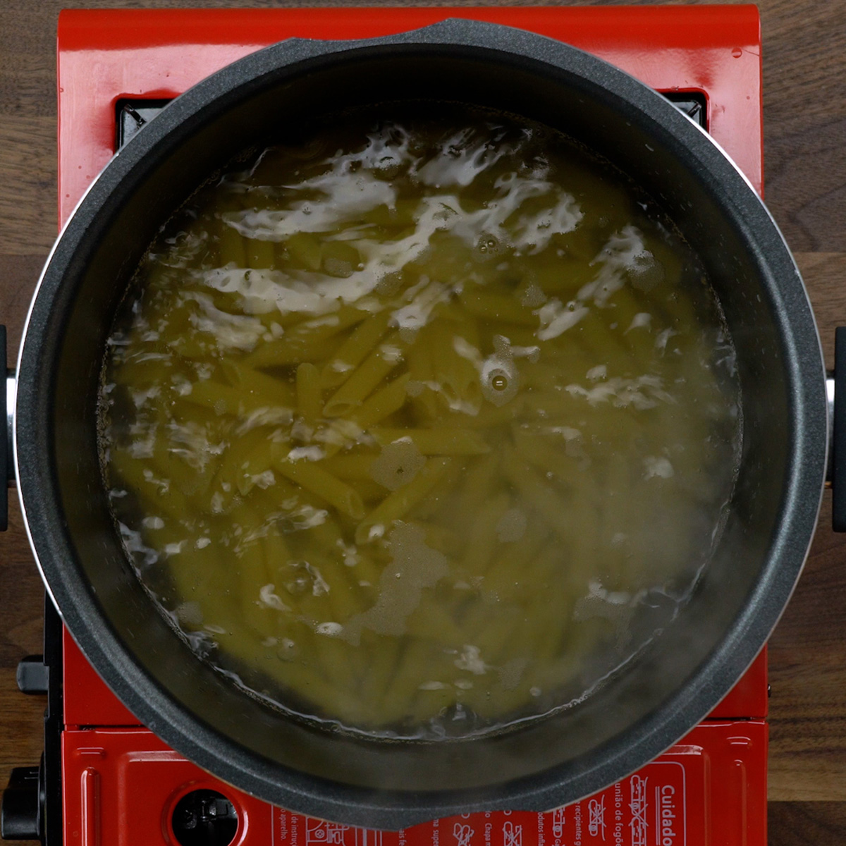 Penne cooking in boiling salted water.