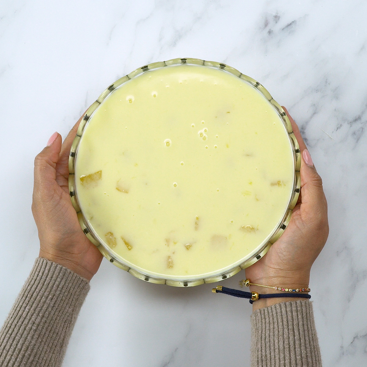 Creamy pineapple mixture in a glass dish before chilling.