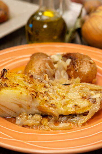 Portuguese baked cod with potatoes served on a plate