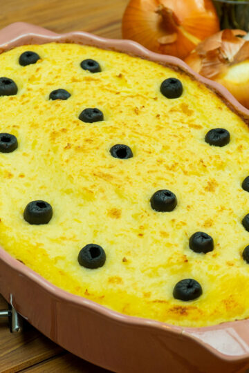 Portuguese cod and mashed potato casserole baked in a serving dish.