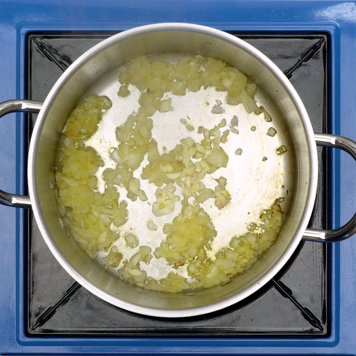 Onion and garlic sautéing in hot olive oil.
