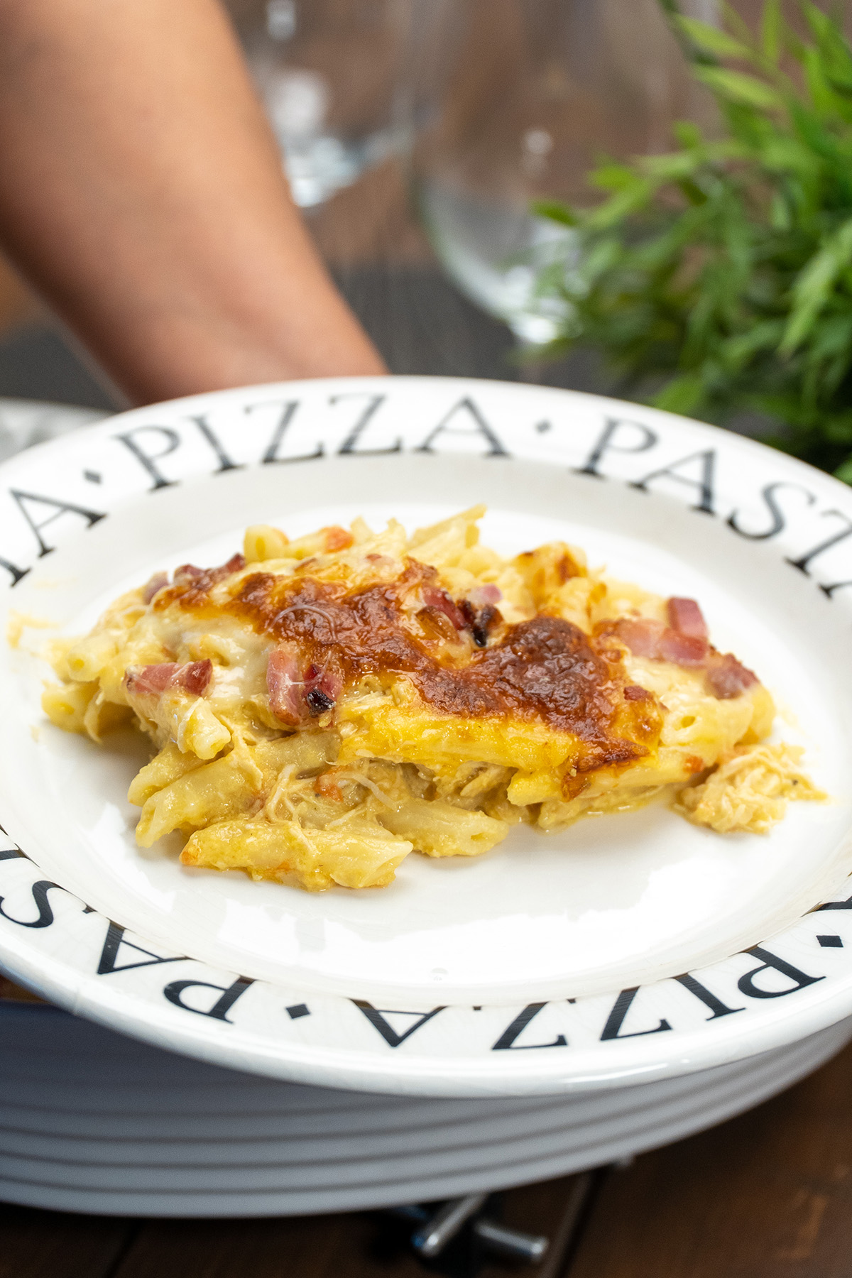 Serving creamy chicken corn penne with bacon and melted cheese.