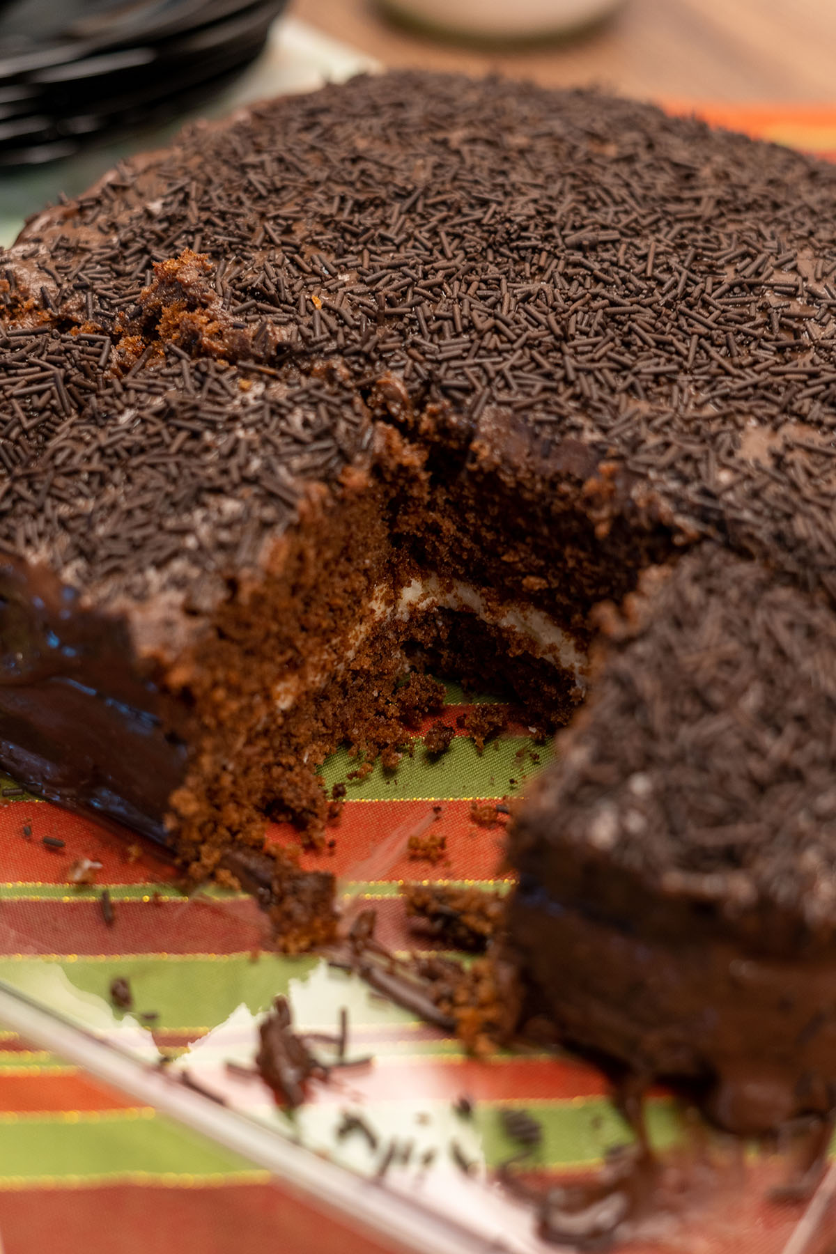 Chocolate coconut layer cake being served in slices.
