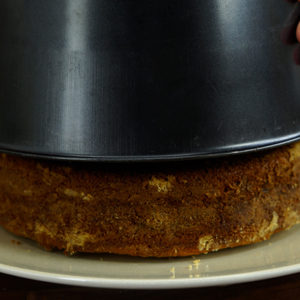 Warm apple cinnamon cake being unmolded onto a plate.